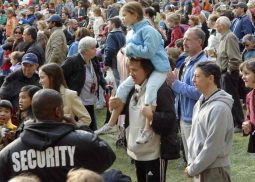 A crowd of people standing around each other.