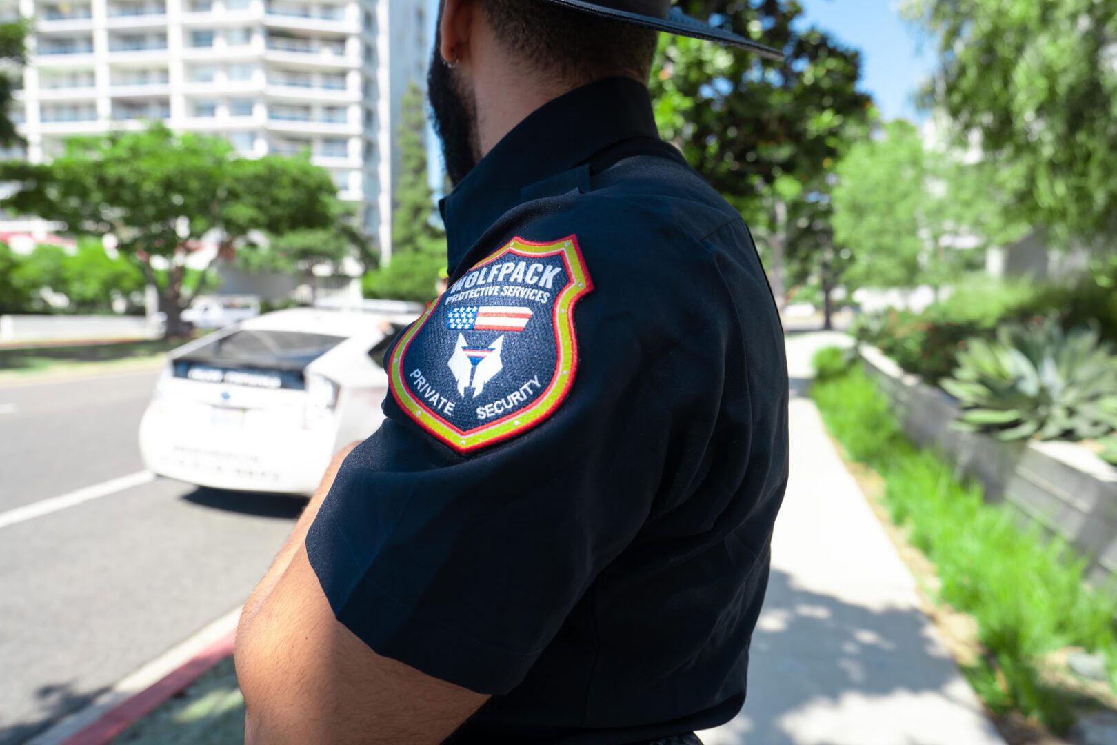 A police officer is standing on the side of the road.