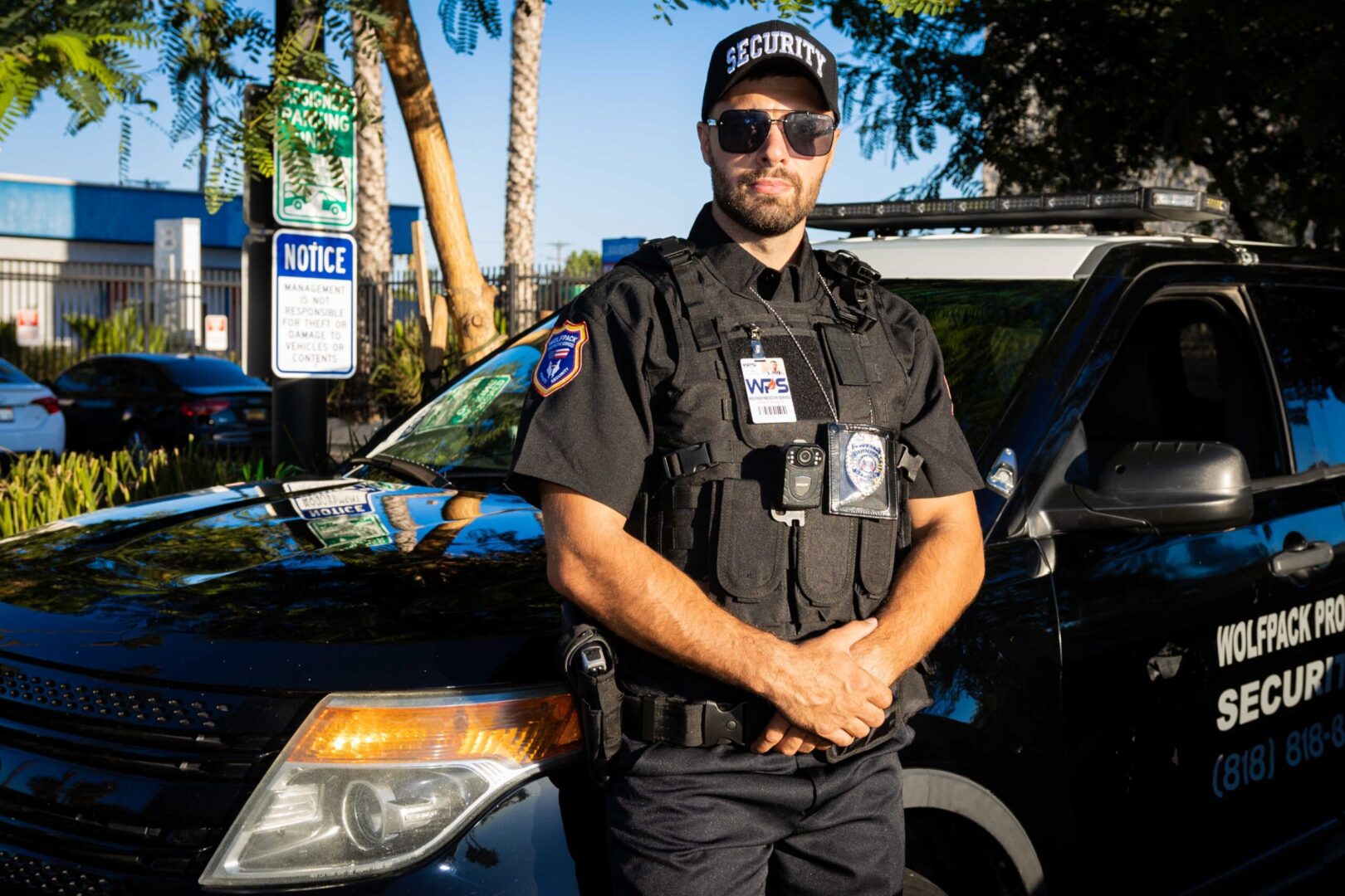 A police officer standing next to his car.